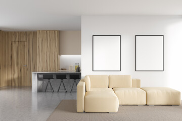 Bright studio interior with two empty white posters, barstools, sofa