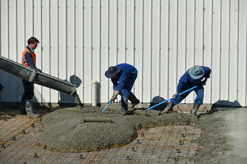 builders spread newly poured cement