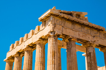 Ruins of Parthenon, Temple of Athena, in Acropolis, Athens, Greece with blue sky in the background