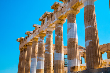 Ruins of Parthenon, Temple of Athena, in Acropolis, Athens, Greece with blue sky in the background