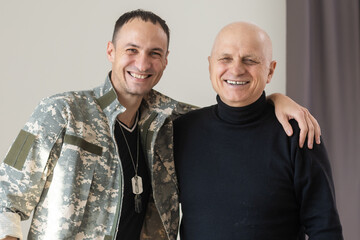 Military father hugs his son when they are reunited after a mission