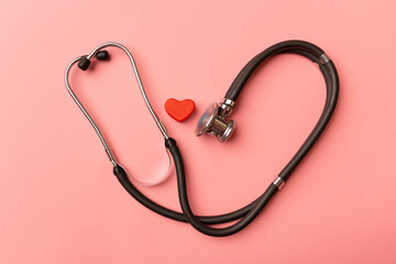 World health and heart day concept. Stethoscope and red heart on pink background. Global health care