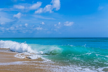 An ocean wave runs up to the beach and wraps itself in a pipe colliding with the previous wave...