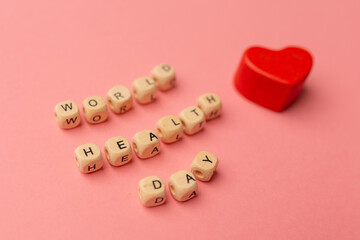 World Health Day, medical and healthcare. Red heart and text World Health Day on pink background