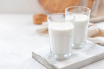 Two glasses of milk on a white background. Side view, copy space.