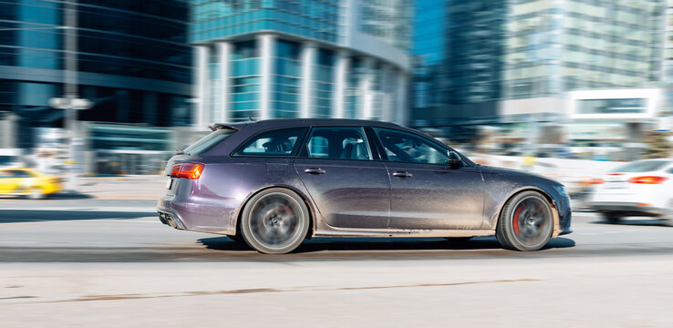 Audi S6 Avant car on the city road. Fast moving violet car on Moscow streets. Accelerating with low-emission. Compliance with speed limits on the road