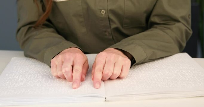 Blind man reading a text of Braille. Braille is a tactile writing system used by people with visual impairments.