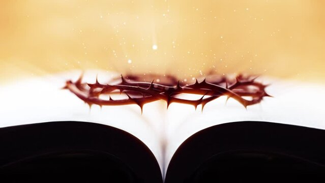 The crown of thorns symbolizing the sufferings of Jesus Christ on the cross, the Bible, and the bright light going up