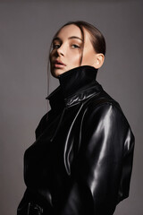 Fototapeta na wymiar fashion portrait of Beautiful woman in leather trench coat