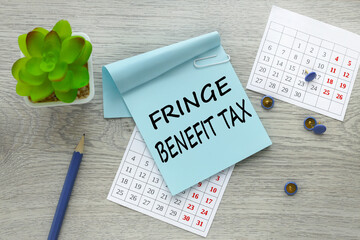 FRINGE BENEFIT TAX text on blue sticker on light table