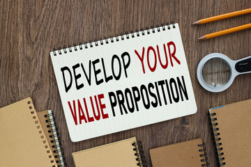 Develop your value proposition. open notepad with text near many notepads and magnifier