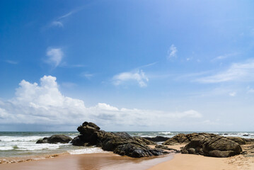 Fototapeta na wymiar Sandy beach with large rocks on western coast of Sri Lanka