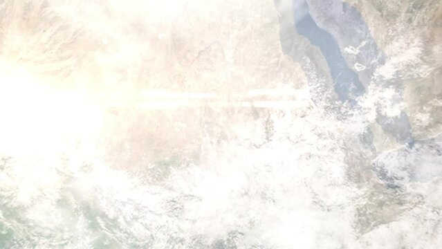 Earth zoom in from outer space to city. Zooming on Wad Madani, Sudan. The animation continues by zoom out through clouds and atmosphere into space. Images from NASA