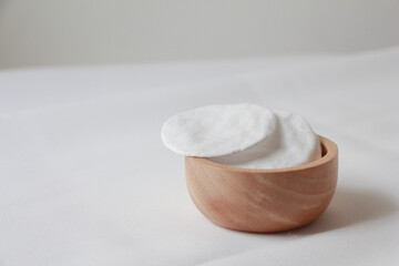 cotton pad in wood on white background. © jajam_e