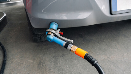 Gas station. Pump fuel petrol in tank car. Gasoline oil in nozzle. Close-up of the hand and the...