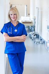 Portrait of Caucasian American female nurse wearing scrubs in hospital corridor