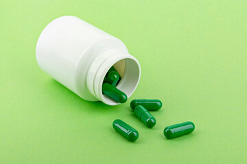 Medicine capsules pouring from a box