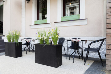 The outdoor cafe is decorated with flower tables.