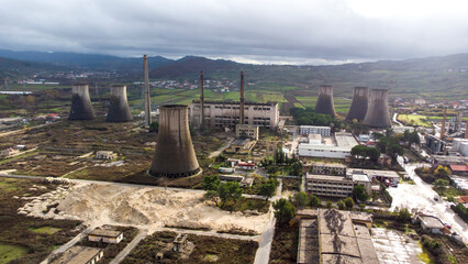 Aerial drone view of decommissioned nuclear power plant. Abandoned factory on a cloudy day. Dark...