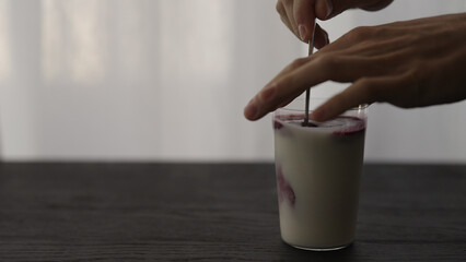 mix berry juice in yogurt in tumbler glass with copy space