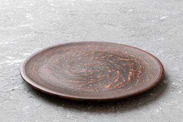 Perspective view of empty plate on cement background. Empty space for your design
