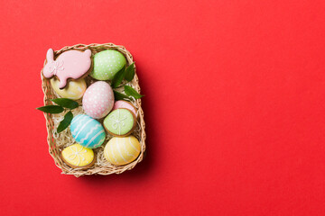 Multi colors Easter eggs in the woven basket on colored background . Pastel color Easter eggs. holiday concept with copy space