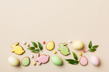 holiday preparation Multi colors Easter eggs with cookies on colored background . Pastel color Easter eggs. holiday concept with copy space