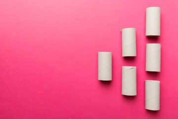 Flat lay composition with empty toilet paper rolls and space for text on color background. Recyclable paper tube with metal plug end made of kraft paper or cardboard