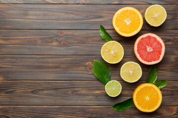 Fruit background. Colorful fresh fruits on colored table. Orange, lemon, grapefruit Space for text healthy concept. Flat lay, top view, copy space