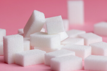 sugar cubes on a pink background.