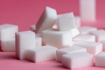 sugar cubes on a pink background.