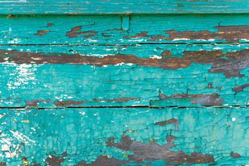 Fototapeta na wymiar Background of old brown wood texture with blue cracked paint, closeup image