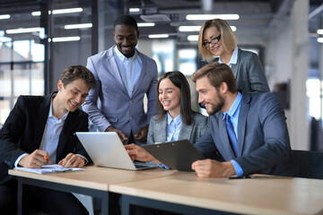 Group of happy young business people in a meeting at office.