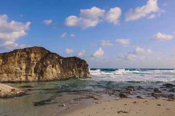 Fototapeta premium Windy and Rocky Coastline of the Mediterranean Sea in the Marsa Matruh city under Blue Cloudy sky with no People around, Egypt