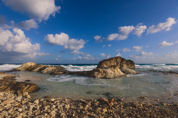 Windy and Rocky Coastline of the Mediterranean Sea in the Marsa Matruh city under Blue Cloudy sky with no People around, Egypt