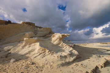 Windy and Rocky Coastline of the Mediterranean Sea in the Marsa Matruh city under Blue Cloudy sky with no People around, Egypt