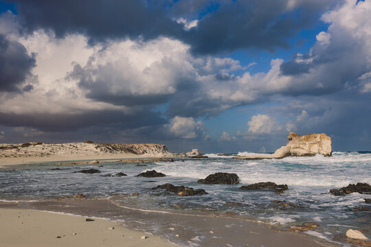 Windy and Rocky Coastline of the Mediterranean Sea in the Marsa Matruh city under Blue Cloudy sky with no People around, Egypt
