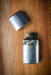 Old vintage lighter on a wooden background
