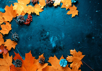 leaves and cones over a rustic wood autumn background