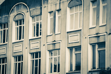 Facade of an old building with many windows. 