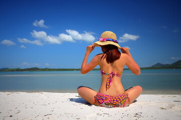 Free action and relaxing of bikini tanned Thai girl on white sand beach at Krabi, Thailand. Concept image for summer vacation in tropical country, Thailand.