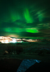 Fototapeta na wymiar Landscape. The Northern lights in the sky beyond the Arctic Circle.