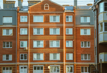 Wall of a new modern high-rise residential building in a residential area. Housing construction. Residential fund. Sleeping residential area.