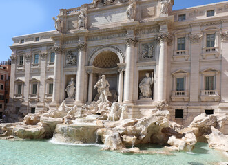 Fototapeta na wymiar God Neptune and other statues in the fountain called Trevi FONTANA in the center of Rome without people