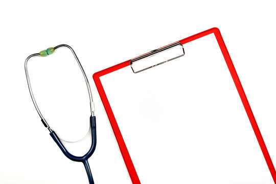 Medical Clipboard With A Stethoscope, On A White Background. View From Above.