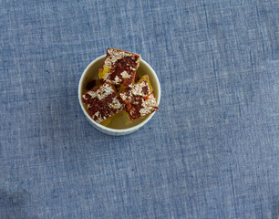 Chocolate Petha also known as Angoori Petha is a popular sweet from Agra,Uttar Pradesh,India. It is made from pumpkin by soaking the pieces in sugar syrup. Top view of petha lying on light background.