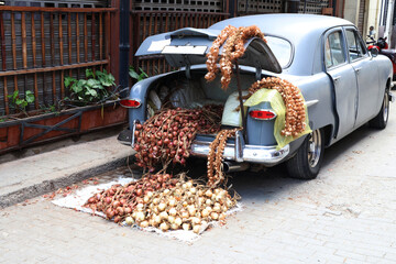 Sale of onions on display in the trunk of a vintage car in Havana, Cuba