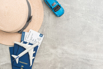 Travel and vacation concept. Trip accessories and items. Airplane toy over passport with airplane tickets and face masks. Top view flat lay with copy space.