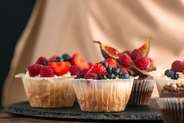 Vanilla and chocolate mousxes with fresh berries. Fruit cakes. Muffins with seasonal fruits.