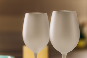 Two empty frosted wine glasses